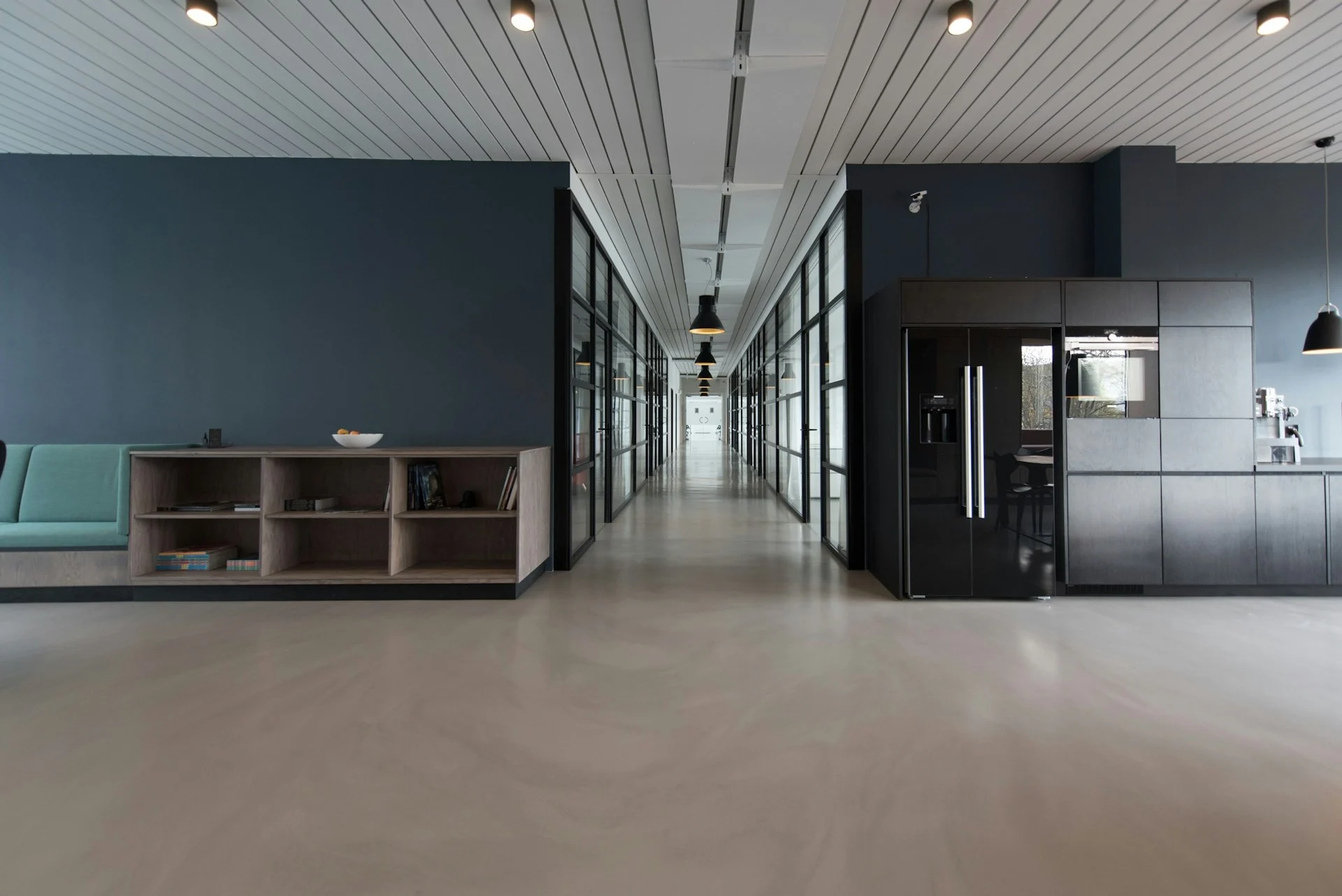Modern open-plan office with glass-walled meeting rooms
