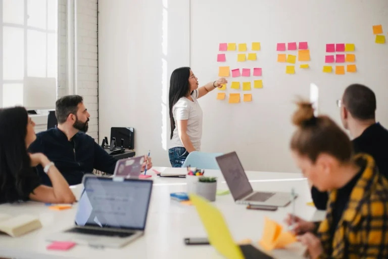 Team brainstorming with sticky notes on a whiteboard
